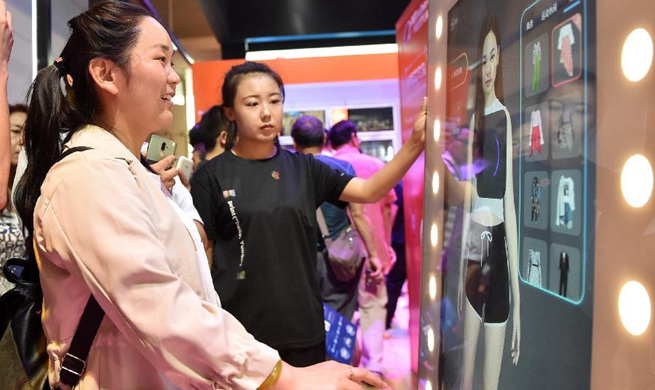 Visitors experience face recognition technology at 2nd World Intelligence Congress