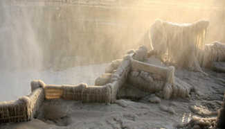 Visitors view frozen Hukou Waterfall on Yellow River